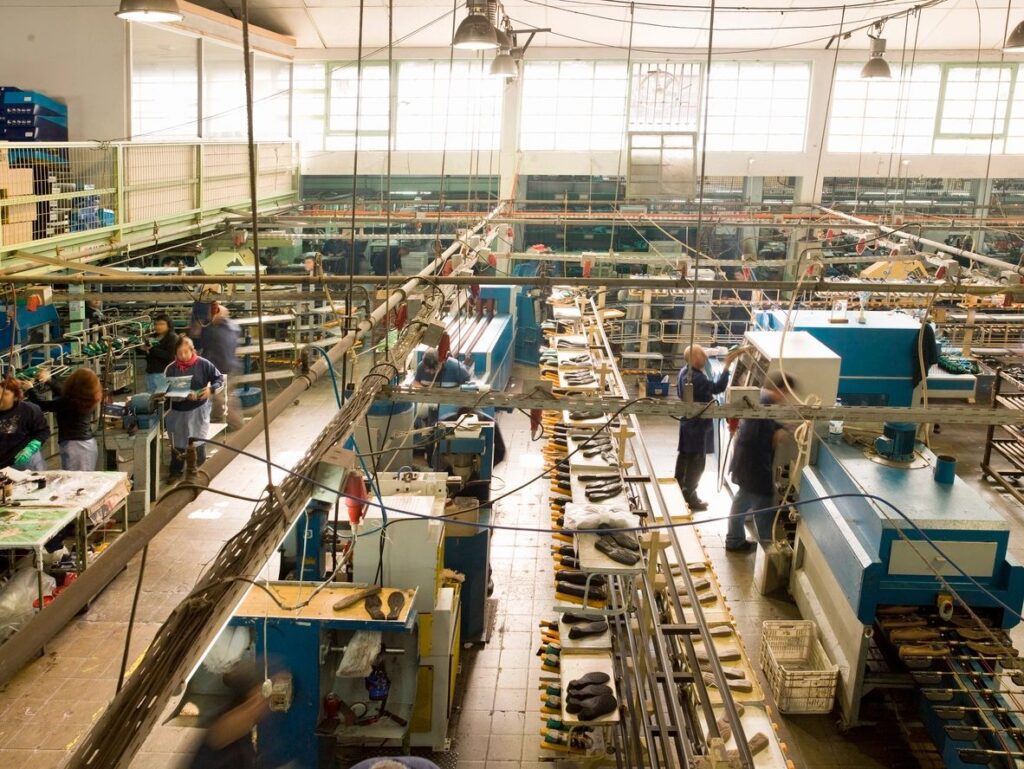 A factory with workers working on machines.